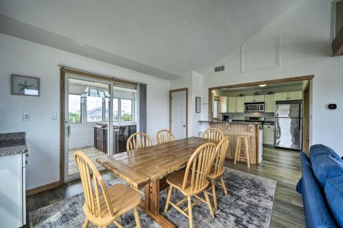 a kitchen and dining room with a wooden table and chairs at Avon Home on the Channel with Hot Tub and Deck! in Avon