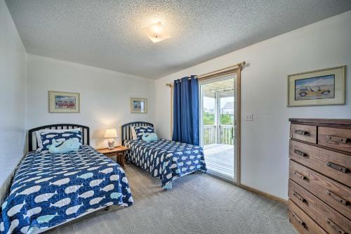 a bedroom with two beds and a sliding glass door at Avon Home on the Channel with Hot Tub and Deck! in Avon