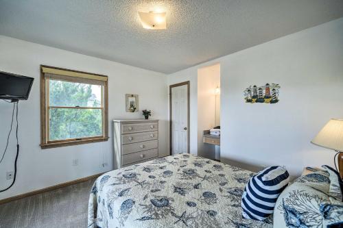 a bedroom with a bed and a window and a dresser at Avon Home on the Channel with Hot Tub and Deck! in Avon