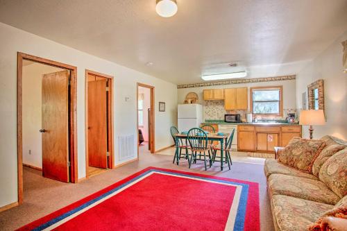 a living room with a couch and a red rug at Cozy, Secluded Davis Cabin on 60 Wooded Acres in Davis