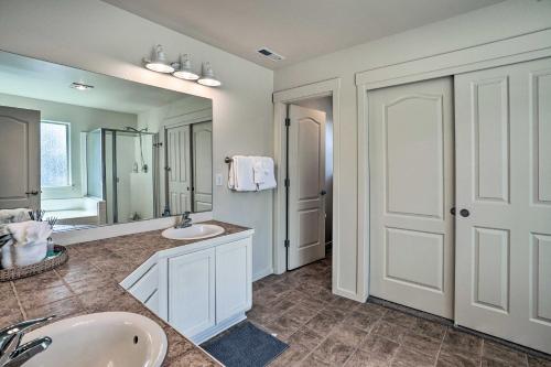 a bathroom with two sinks and a large mirror at Serene Bend Getaway with Hot Tub and Fire Pit! in Bend