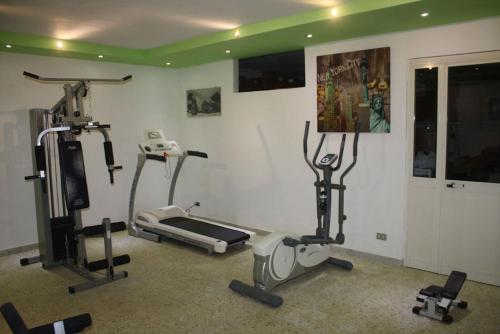a gym with several exercise equipment in a room at Villa Delle Camelie in Gragnano