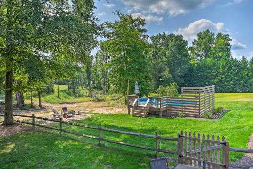 a yard with a fence and a playground at Peaceful Country Retreat with Easy Highway Access! in Monticello
