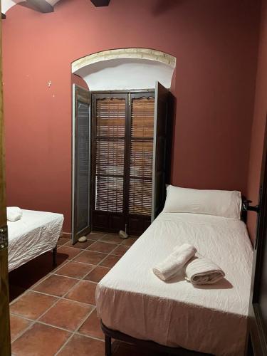 Ένα ή περισσότερα κρεβάτια σε δωμάτιο στο Casa Los pinceles de Murillo