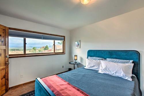 a bedroom with a blue bed and a window at El Prado Duplex with Deck and Grill - 4 Mi to Town! in El Prado