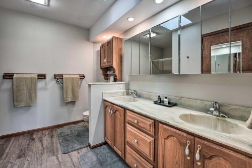 a bathroom with two sinks and a mirror at Welcoming Sturgis Getaway with Spacious Yard! in Sturgis