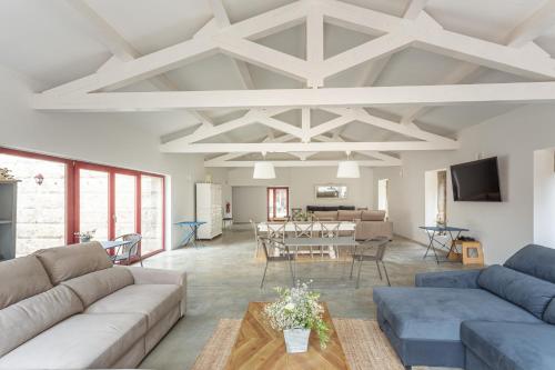 a living room with couches and a dining room at Quinta de Fermil - Casas in Vouzela