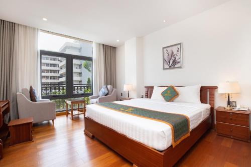 ホーチミン・シティにあるSilk Hong Ha airport hotelのベッドと大きな窓が備わるホテルルームです。
