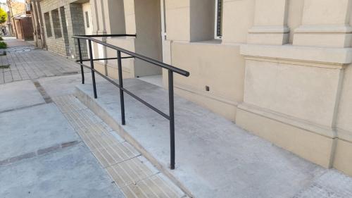 a black railing on the side of a building at Suite in Tres Arroyos
