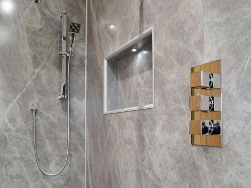 a bathroom with a shower with a mirror and a shower at Sweet Meadow Lodge in Llandrindod Wells