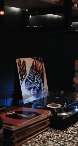 a glass table with a pair of shoes on a picture at Hotel Dryce in Fort Worth
