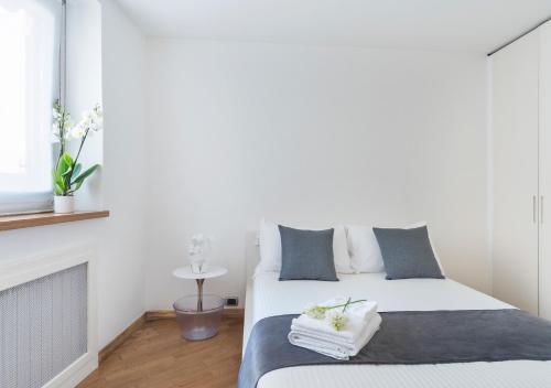 a bedroom with a bed with towels on it at Fiorentini Residence NAPOLI in Naples