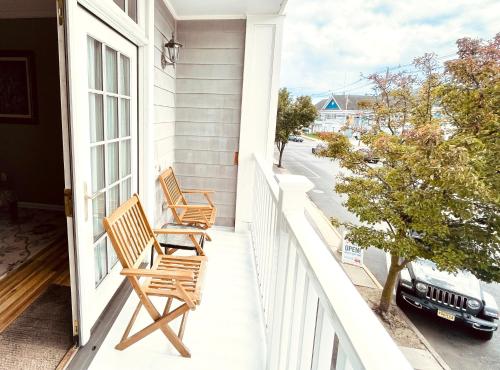 two chairs sitting on the porch of a house at Inn on Main Hotel in Manasquan