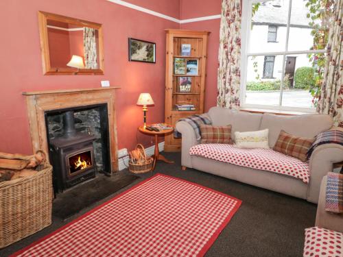 a living room with a couch and a fireplace at Bod Gwynedd in Betws-y-coed