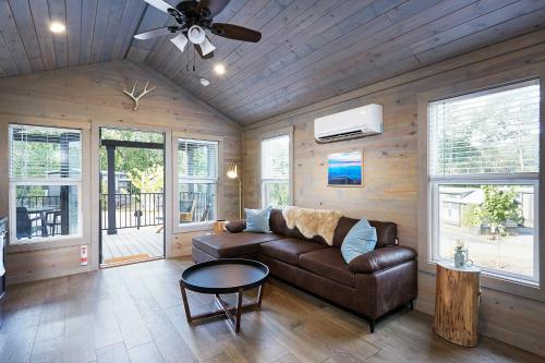 a living room with a couch and a table at Asheville River Cabins in Arden