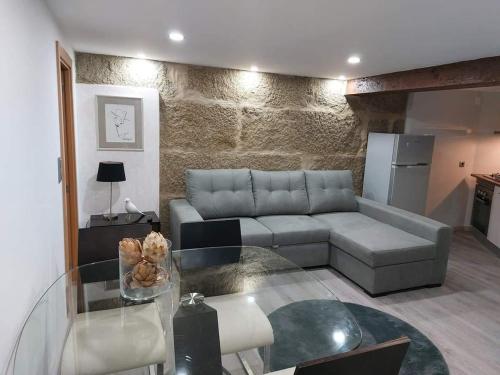 a living room with a couch and a glass table at Casas Zé Pinto in Hospital
