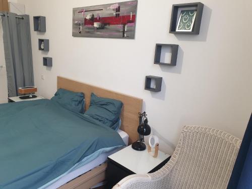 a bedroom with a bed and a table and a chair at Super F3 a côté de Disney Land et Paris in Thorigny-sur-Marne