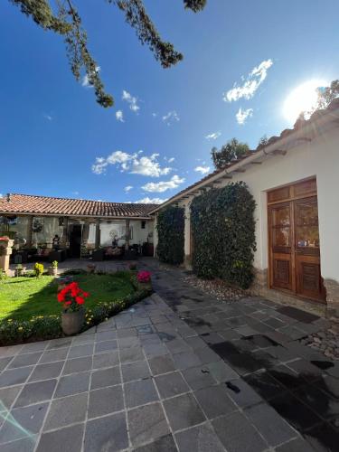 a house with a patio and a driveway at Palacio Manco Capac by Ananay Hotels in Cusco