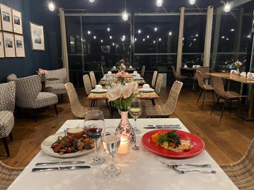 a table with plates of food and wine glasses at Palacio Manco Capac by Ananay Hotels in Cusco
