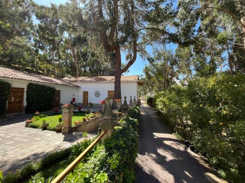 a house with a tree in the yard at Palacio Manco Capac by Ananay Hotels in Cusco