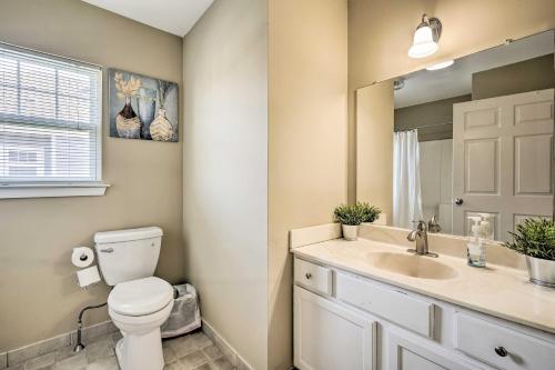 a bathroom with a toilet and a sink and a mirror at Atlantic City Home - Close to Casinos and Beach in Atlantic City
