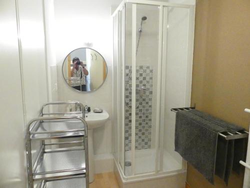 une personne prenant une photo d'une douche dans une salle de bains dans l'établissement Chalet Le Télémark, à Thollon-les-Mémises