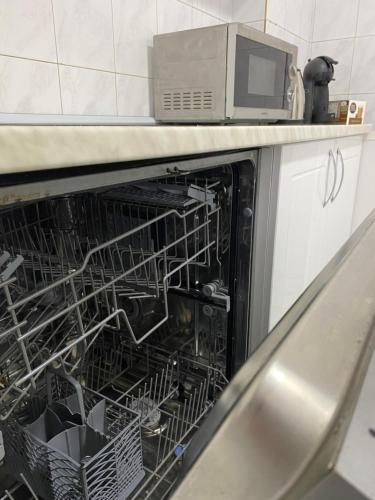 a dishwasher with its dishes inside of it at Belgrade centrum in Karaburma