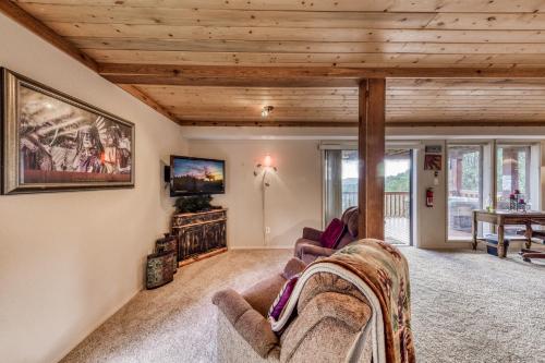 a living room with a couch and a tv at Living the Dream, 3 Bedrooms, Hot Tub, Fireplace, Sleeps 6 in Ruidoso