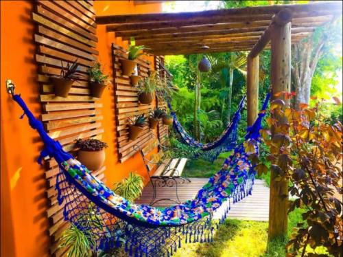 a hammock on the side of a house at Casa aluguel Abraão 1, Ar in Abraão