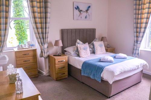 a bedroom with a bed with two towels on it at Balyett Farmhouse B&B in Stranraer