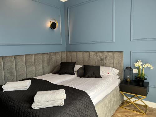 a bedroom with two beds with towels on them at Family & Business Sauna Tężnia Apartments No 20 Leśny nad Zalewem Cedzyna - 1 Bedroom with Private Sauna, Bath with Hydromassage , Terrace, Parking, Catering Options in Kielce