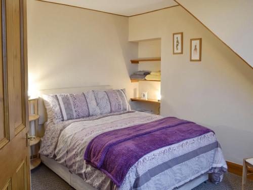 a bedroom with a bed with a purple blanket at Toab - Uk5662 in Aberdeen