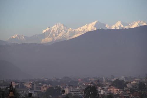 a view of a city with mountains in the background at k2Homes in Pātan