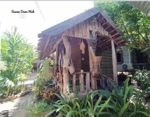 a small wooden house with a fence in front of it at Sala Thongyon - Guest House in Savannakhet