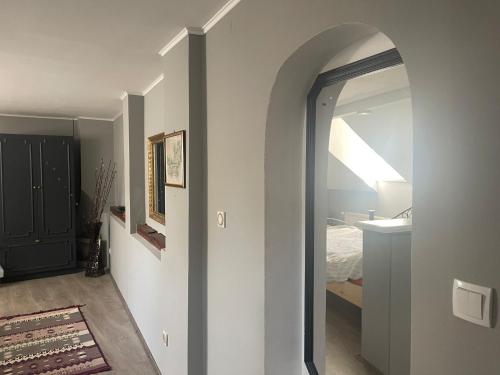 a hallway with an archway leading to a bedroom at Simovic in Čačak