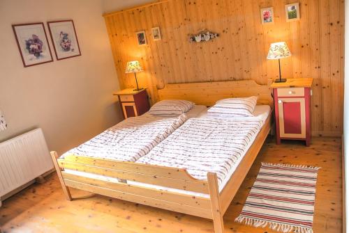 a large bed in a room with two night stands at Marx Bauernhaus 