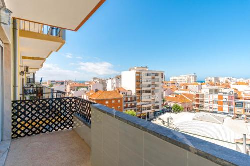 a balcony with a view of a city at Lovely 2 Bedroom Apartment in Caparica in Almada