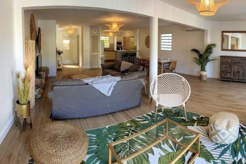 a living room with a blue couch and chairs at Villa Zami in Saint Martin