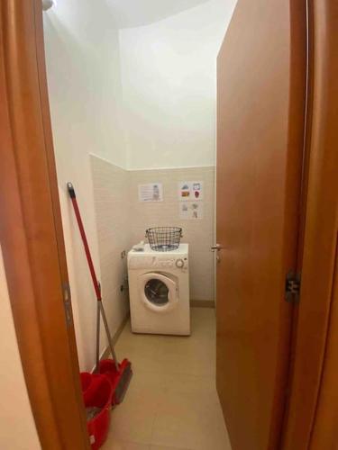 a small bathroom with a washing machine and a washer at Sunny Home:Palo del Colle in Palo del Colle