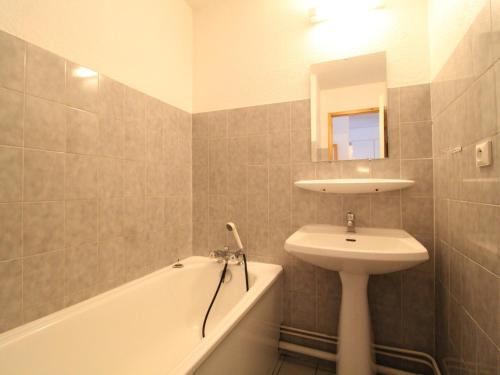 a bathroom with a sink and a bath tub and a sink at Appartement Termignon, 2 pièces, 4 personnes - FR-1-508-99 in Termignon