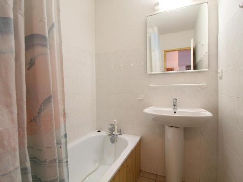a white bathroom with a sink and a bath tub at Appartement Termignon, 2 pièces, 4 personnes - FR-1-508-193 in Termignon