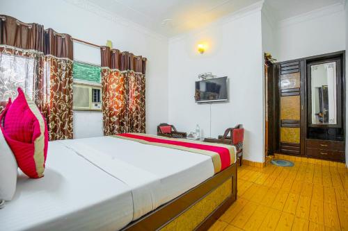 a bedroom with a bed and a window at HOTEL ARINA in Chandīgarh