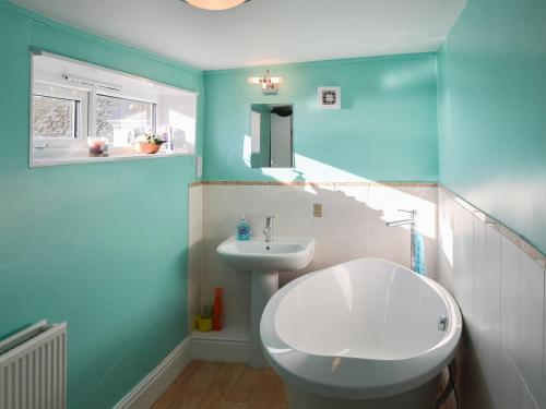 a bathroom with a white sink and a toilet at Mallams in Castletown