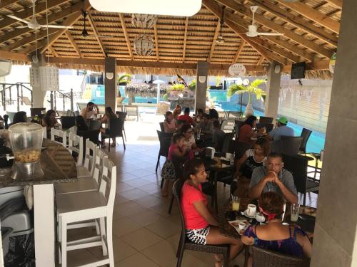 a group of people sitting in a restaurant at El Cabarete Boutique Hotel in Cabarete