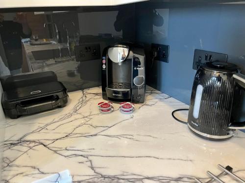 a counter with a coffee maker and a toaster on it at Portobello Living in London