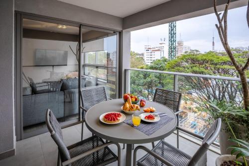 a table with fruit on top of a balcony at Noon Vila Madalena in Sao Paulo