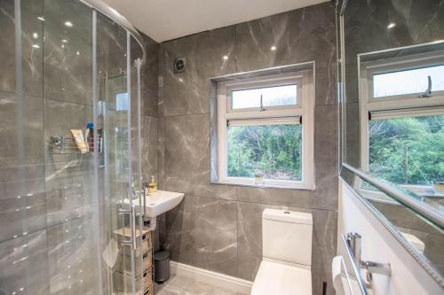 a bathroom with a shower and a sink and a toilet at Sophisticated Home with Beautiful & Large Garden in Cardiff