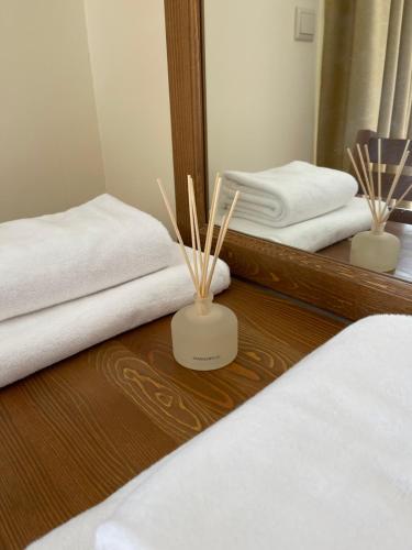 a room with two beds and a mirror with sticks at Allure in Pirin Golf in Razlog