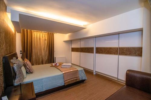 a bedroom with a large bed and a window at Optasia Luxury House in Argos