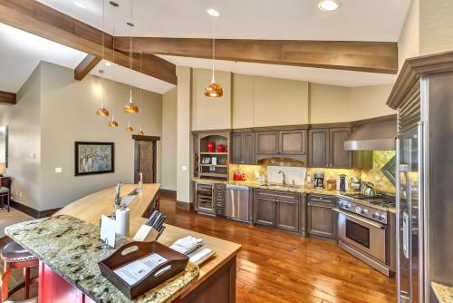 a large kitchen with wooden cabinets and a large island at The Chateaux Deer Valley in Park City